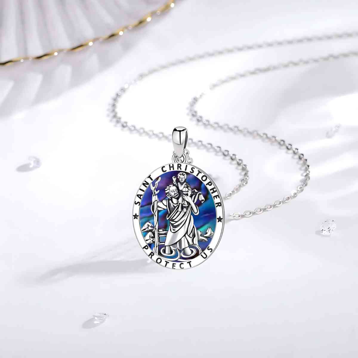 Oval Saint Christopher Necklace Sterling Silver Displayed on White Surface Xenos Jewelry