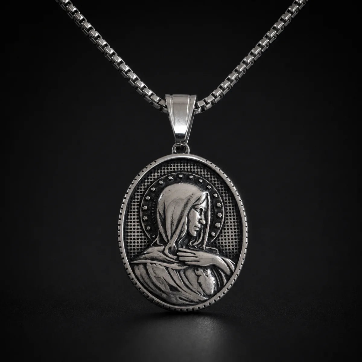 Oval Virgin Mary Necklace with Stars Silver Close Up Black Background