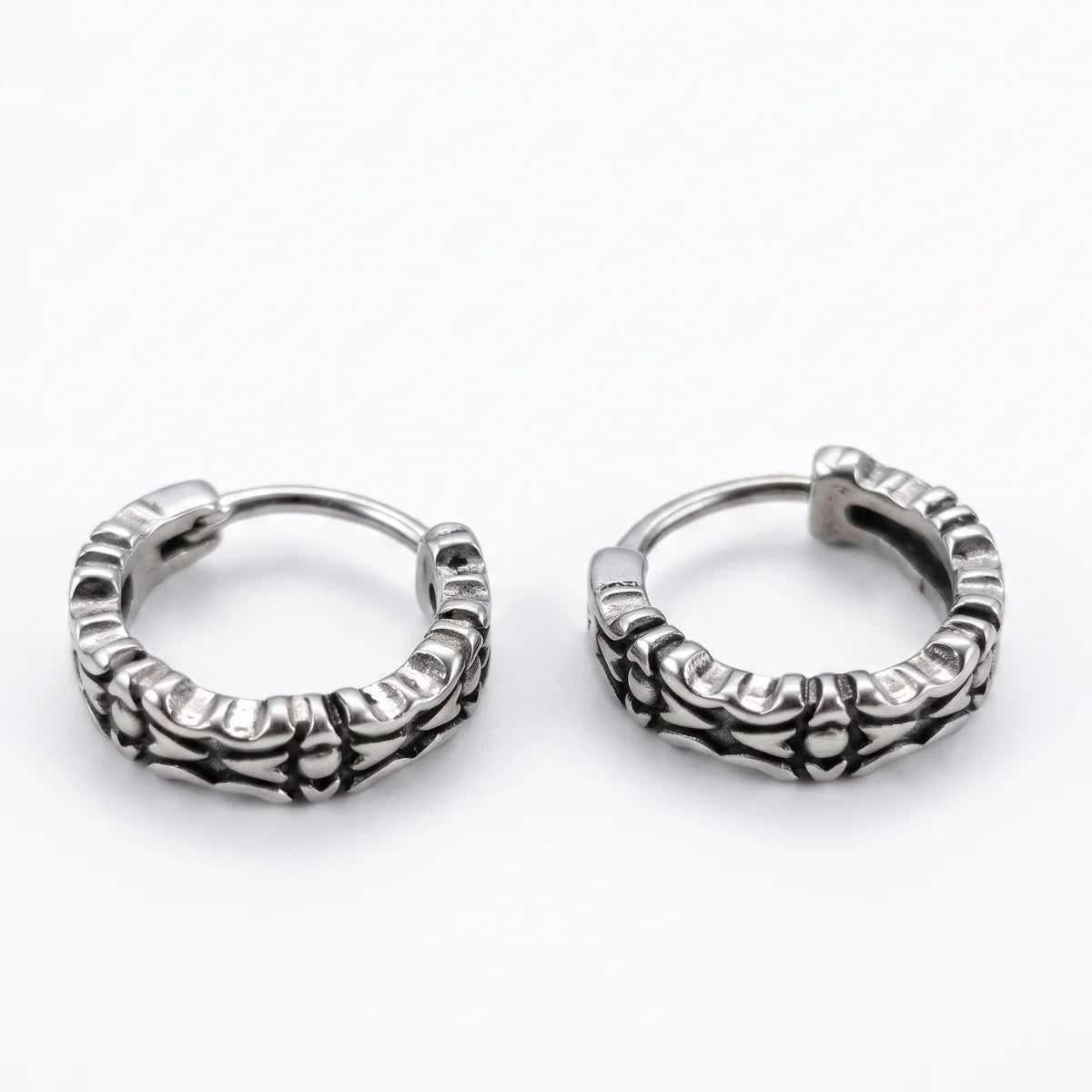Oxidized Carved Hoop Earrings Silver Lying Down White Background