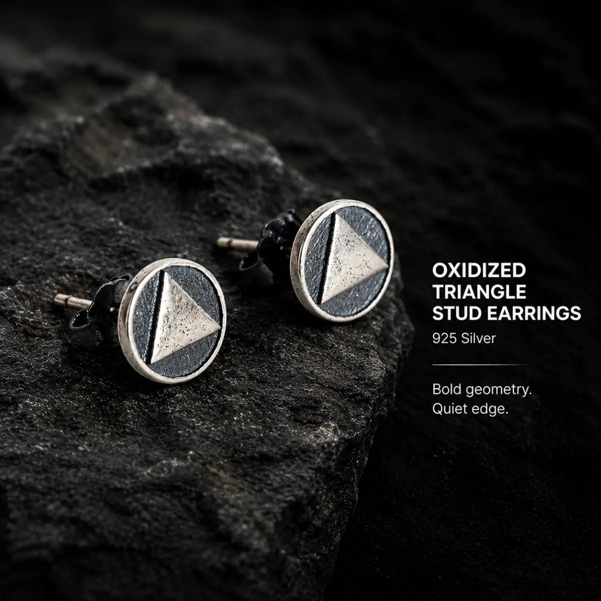 Oxidized Triangle Stud Earrings Silver Pair Displayed on Stone Surface
