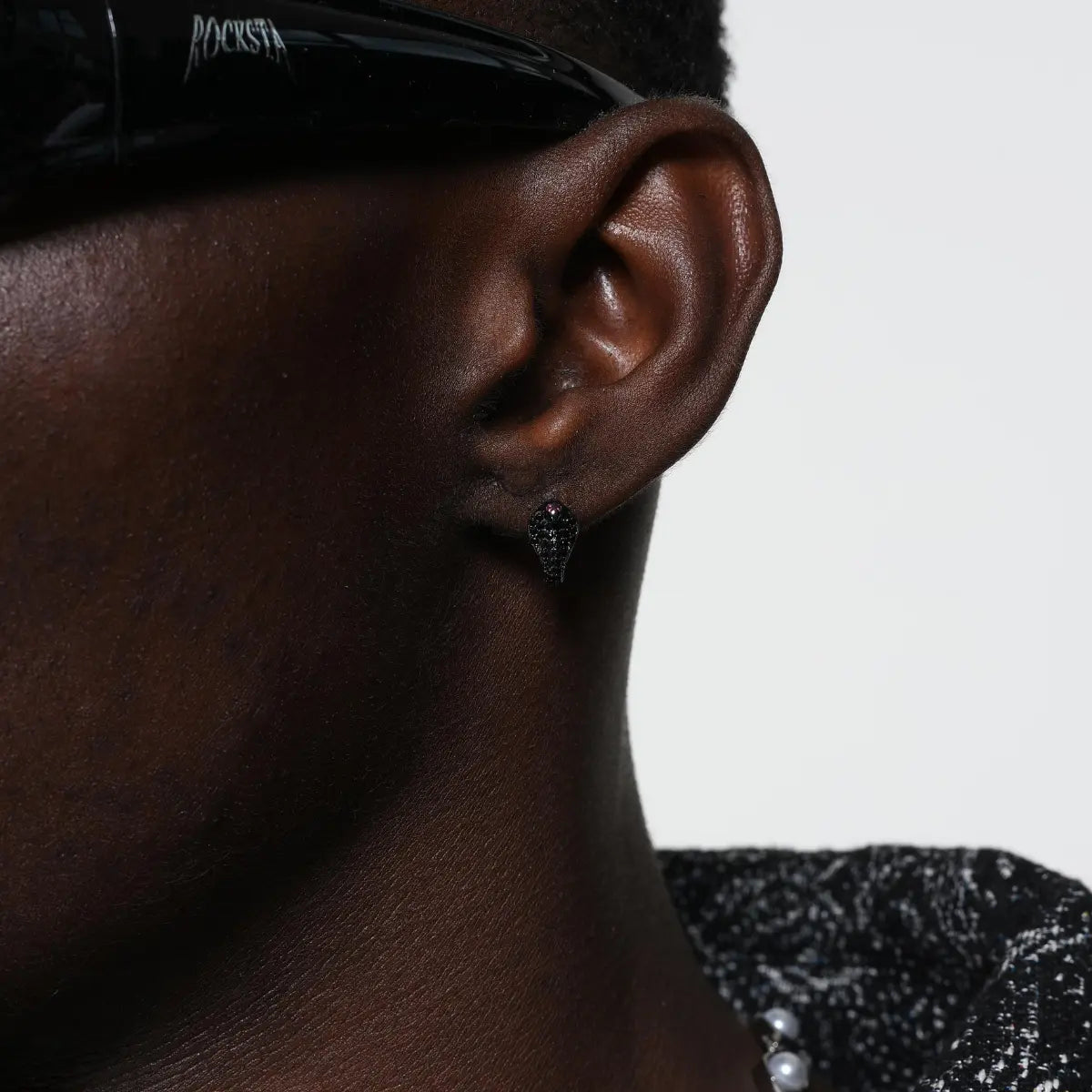 Pave diamond cobra earrings black front worn by male model