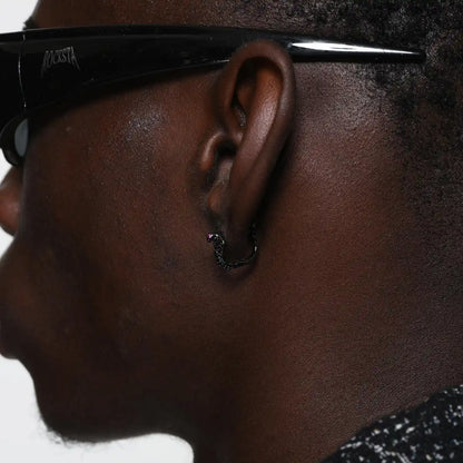 Pave diamond cobra earrings black side worn by male model