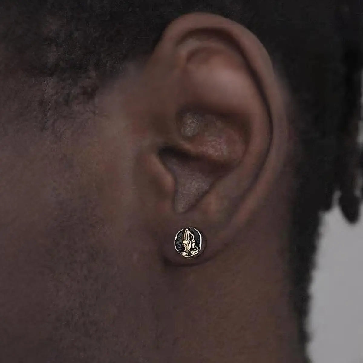 Praying Hands Earrings Gold Worn by Male Model Close Up
