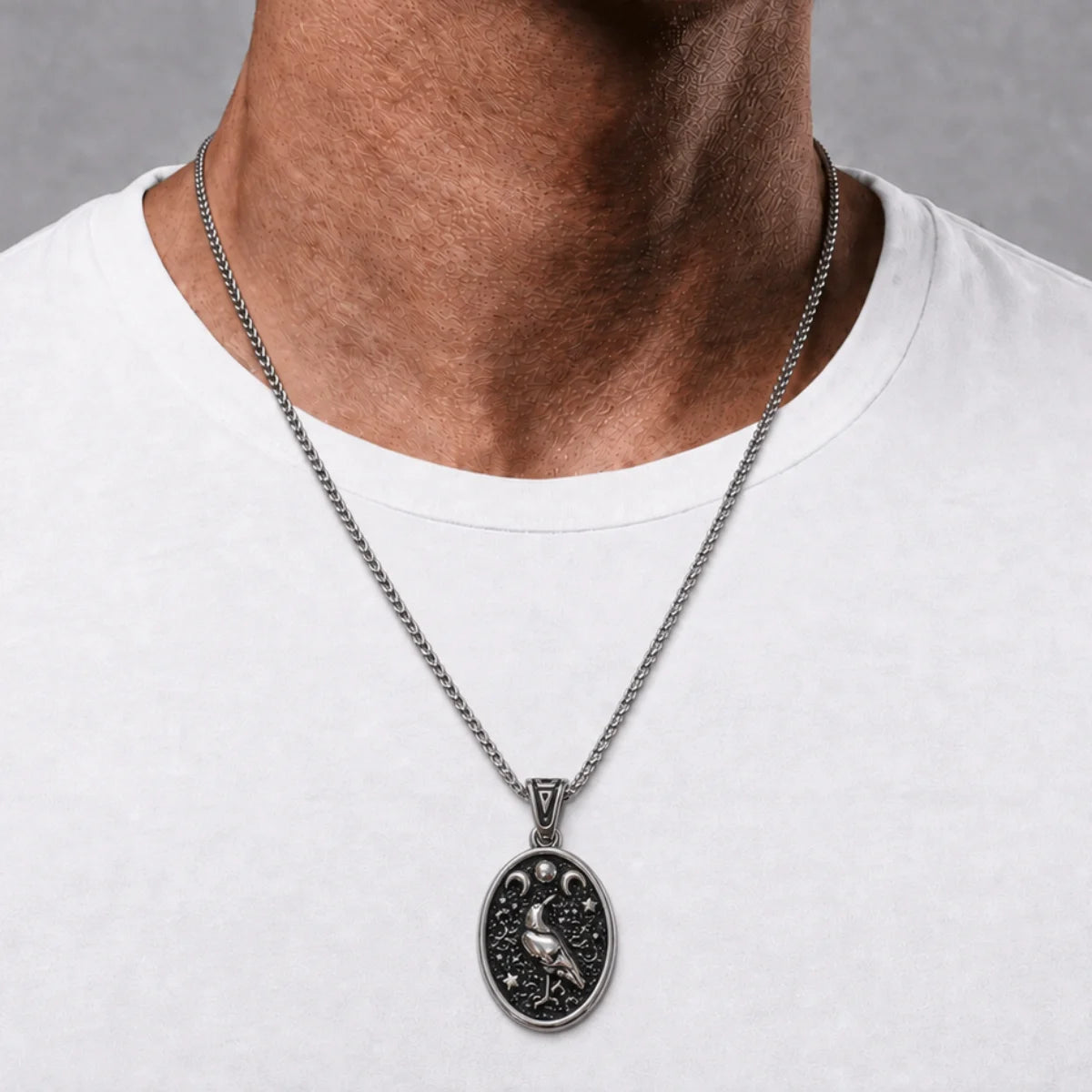 Raven Moon Pendant Necklace Silver Worn by Male Model Chest View
