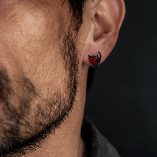 Ruby Heart Skeleton Hand Stud Earrings Worn by Male Model Close Up