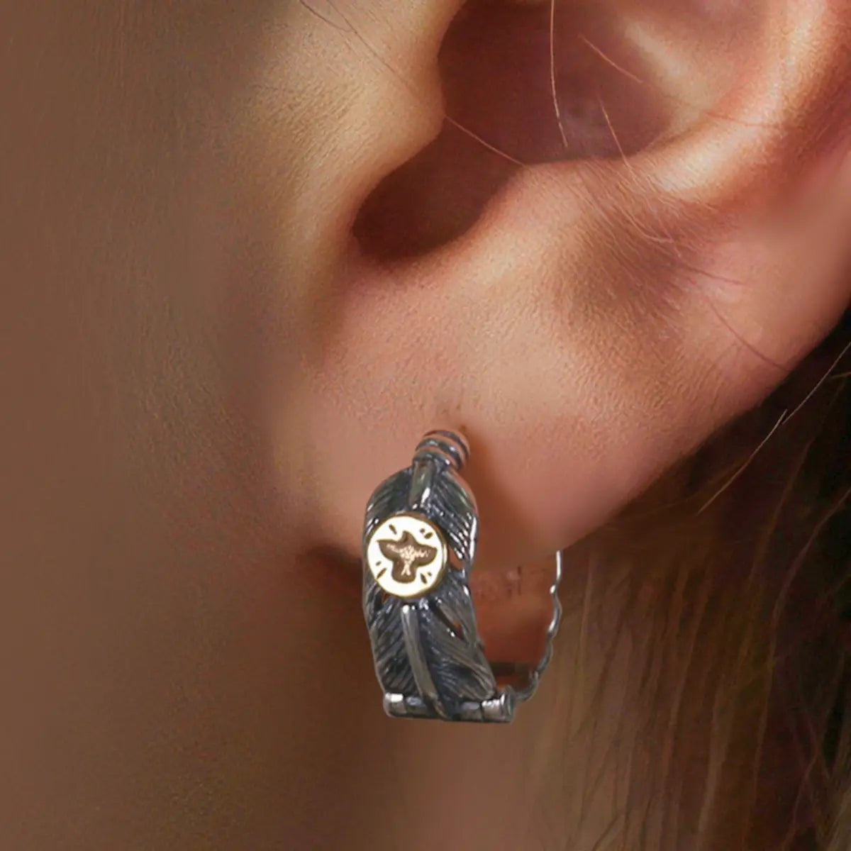 Silver Feather Huggie Hoop Earrings Worn by Female Model Close Up