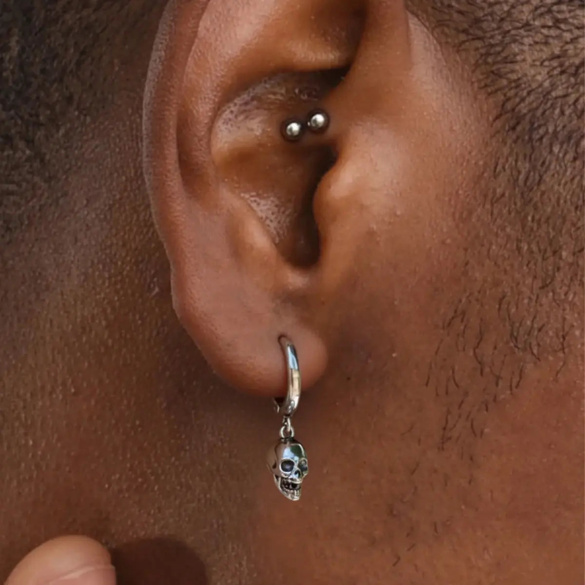 Silver Skull Head Hoop Earrings Worn by Male Model