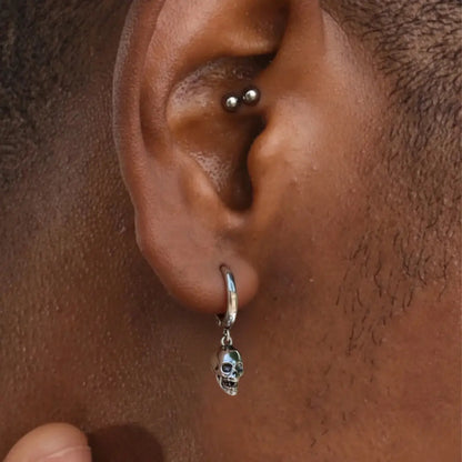 Silver Skull Head Hoop Earrings Worn by Male Model