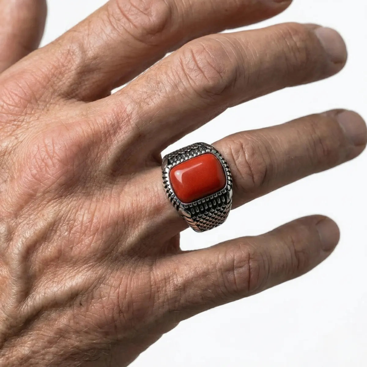 Silver Textured Red Stone Ring Worn by Male Model Close Up
