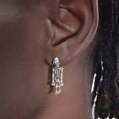 Skeleton dangle earrings sterling silver worn by male model close up