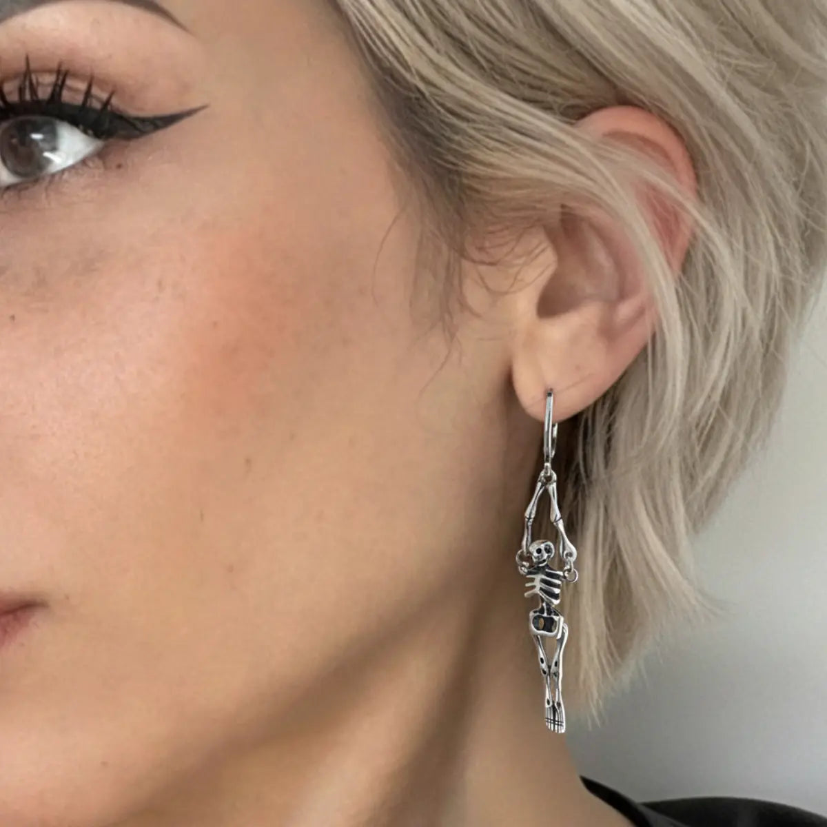 Skeleton Dangle Hoop Earrings Worn by Female Model