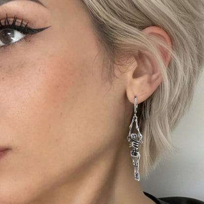 Skeleton Dangle Hoop Earrings Worn by Female Model