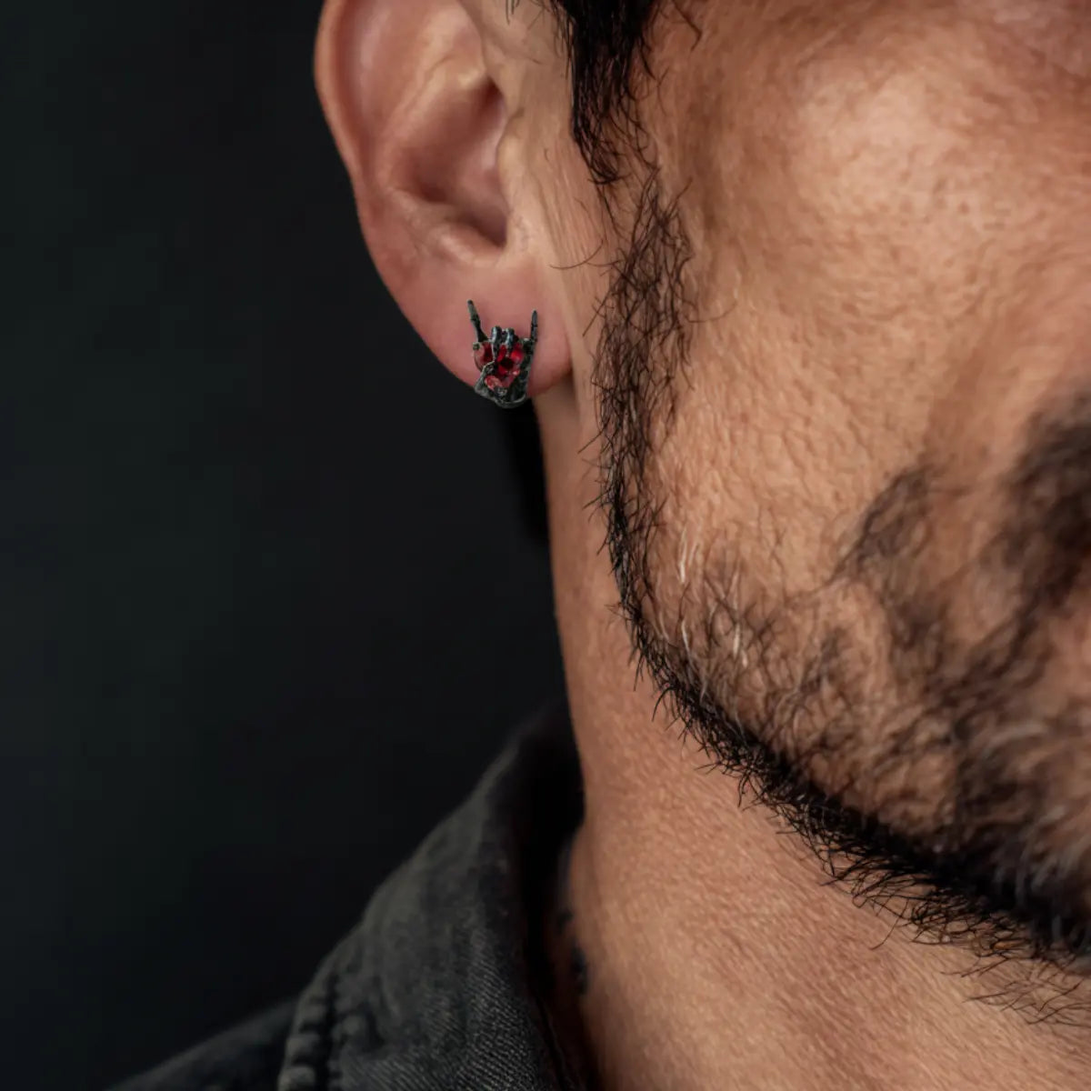Skeleton Hand Heart Stud Earrings Worn by Male Model Front