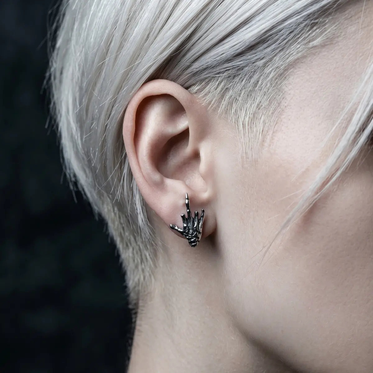 Skeleton Middle Finger Stud Earrings Stainless Steel Worn by Female Model