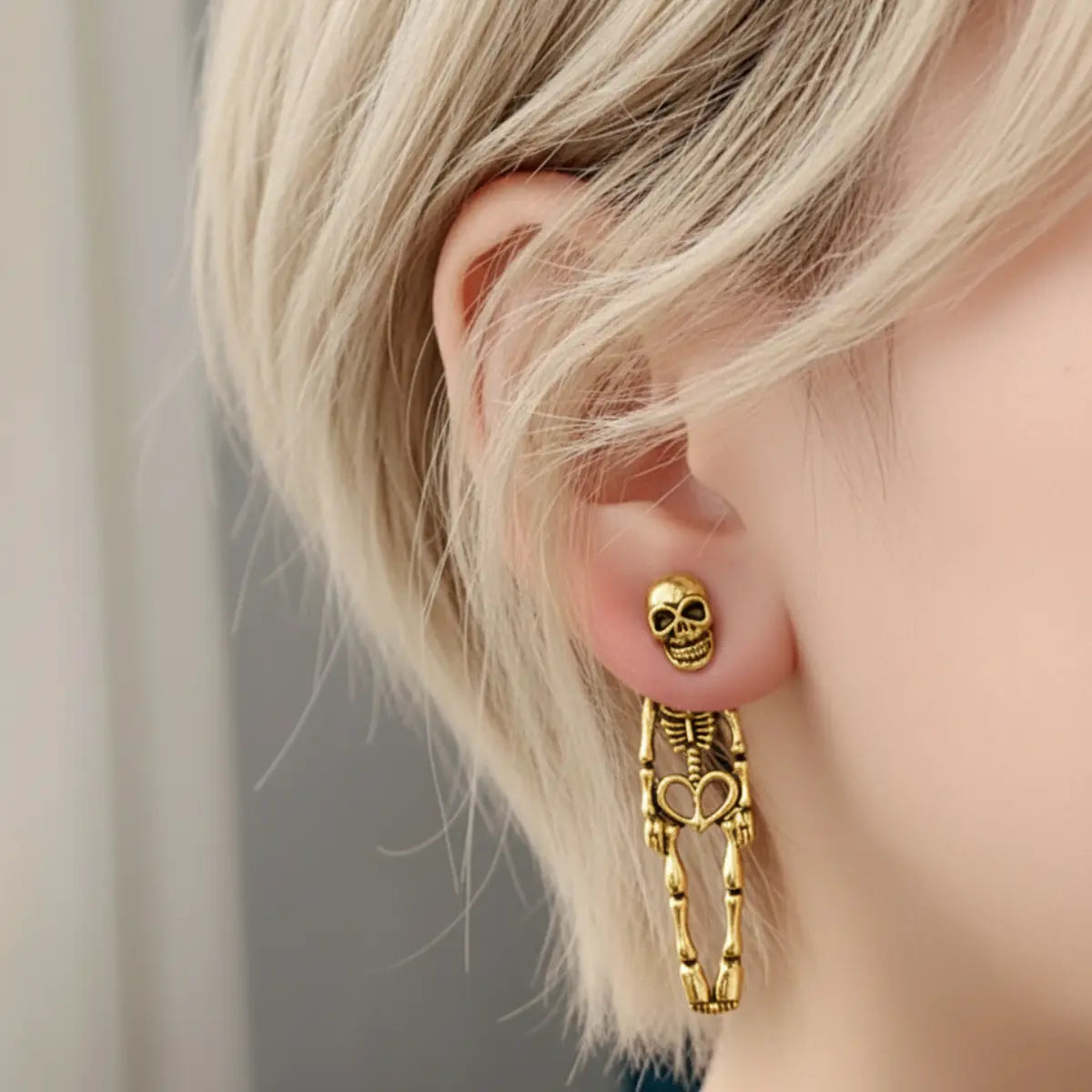 Skeleton Stud Dangle Earrings Gold Worn by Female Model