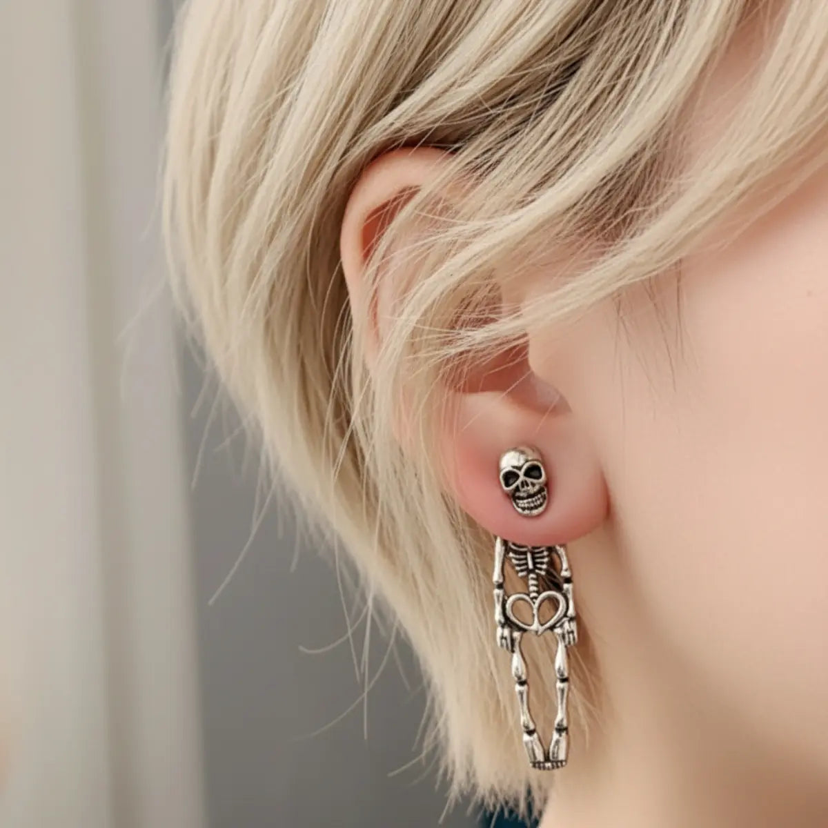 Skeleton Stud Dangle Earrings Silver Worn by Female Model