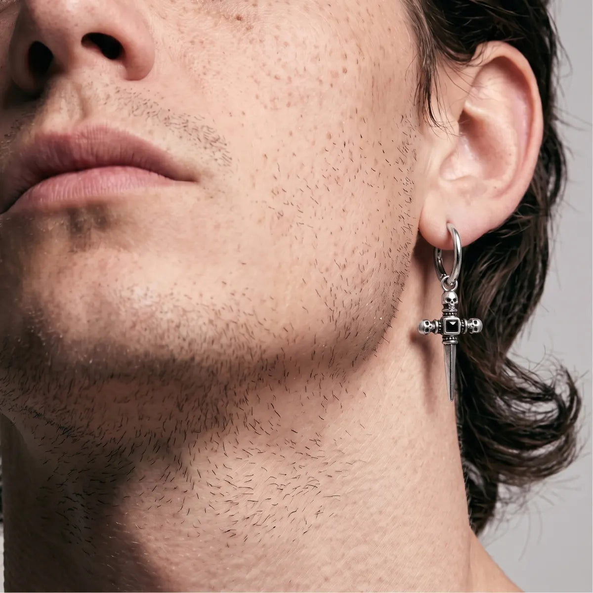 Skull Dagger Hoop Earrings Silver Worn by Male Model Look Up