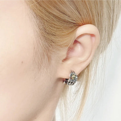 Skull Skeleton Hand Huggie Hoop Earrings Worn by Female Model