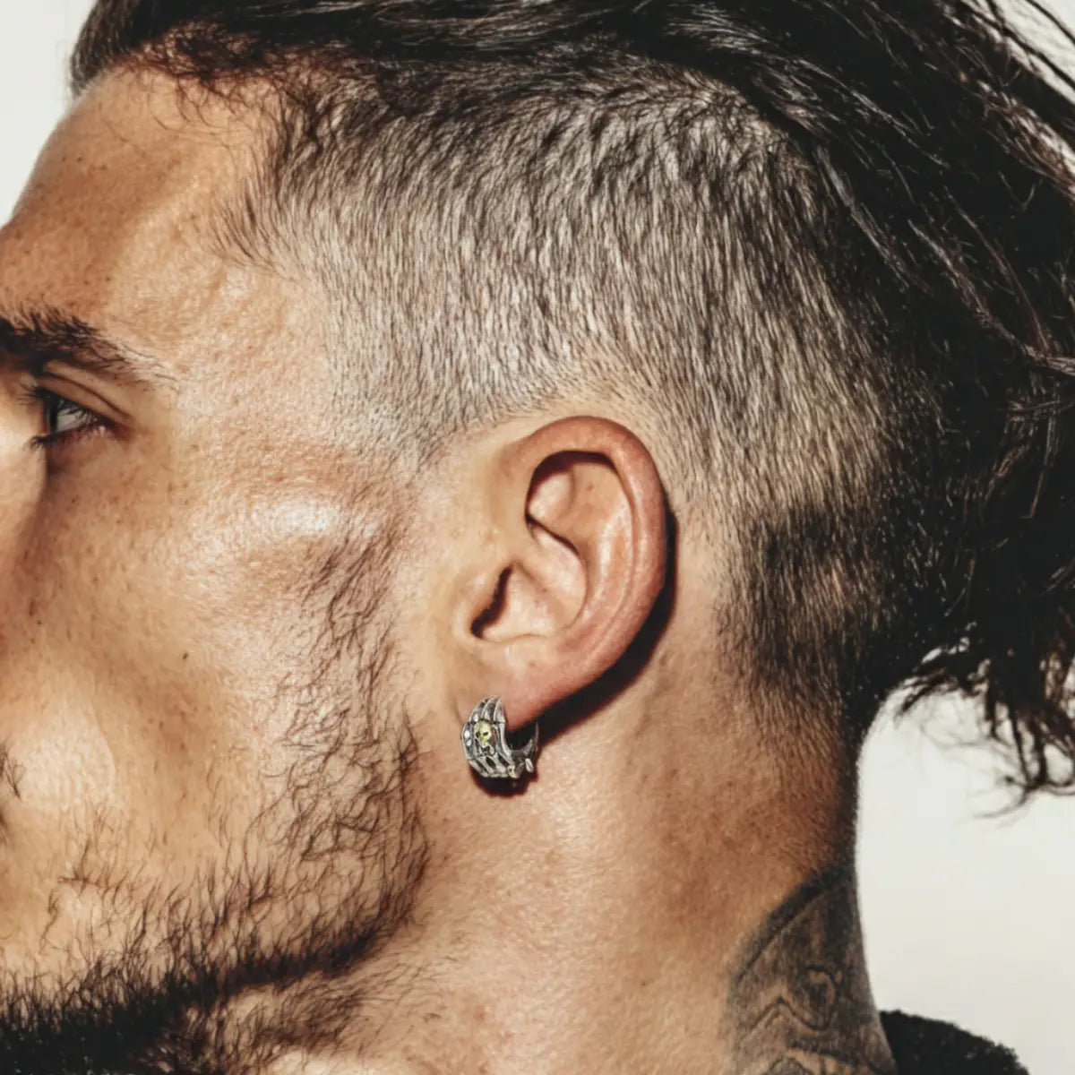 Skull Skeleton Hand Huggie Hoop Earrings Worn by Male Model