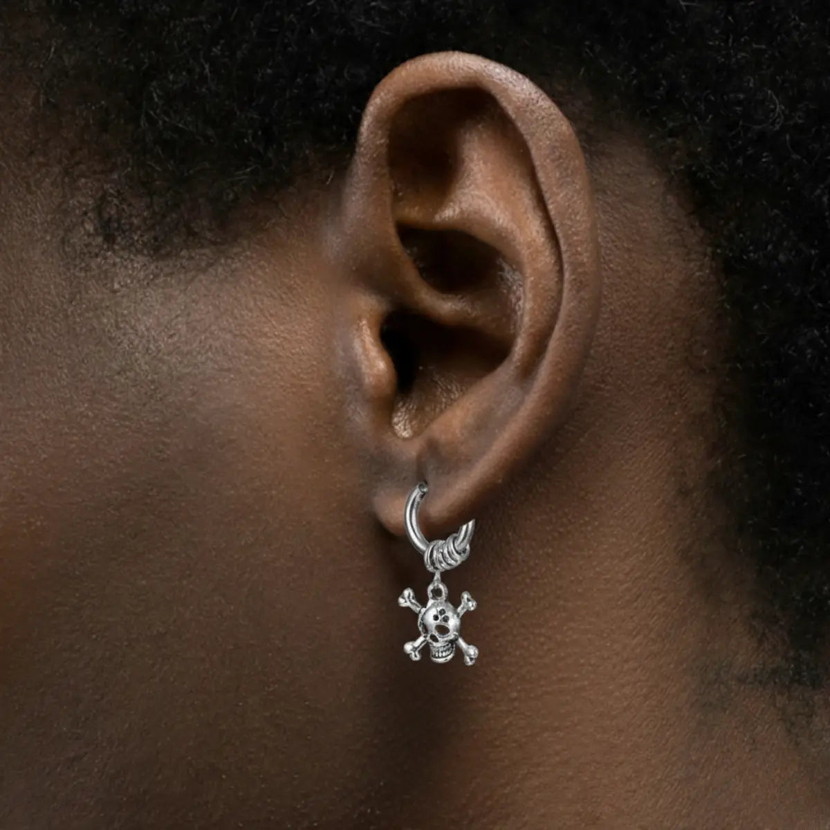 Skull and Crossbones Dangle Hoop Earrings Silver Worn by Male Model