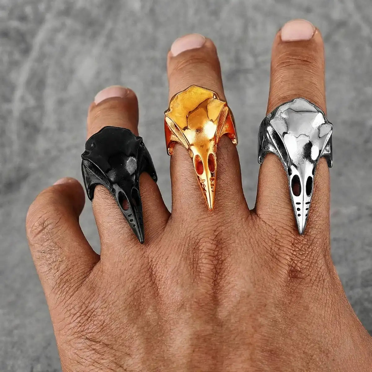 Sleek Raven Skull Rings Gold Silver and Black Worn by Male Model Close Up