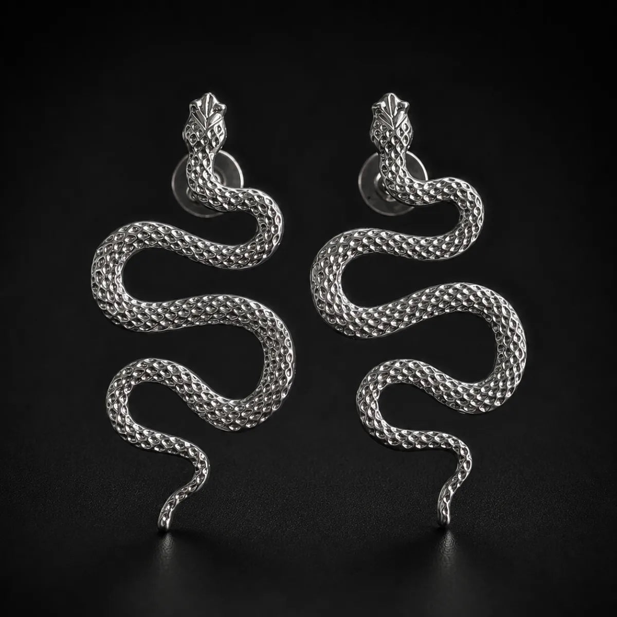 Snake Drop Earrings for Women Silver Pair Close Up Black Background