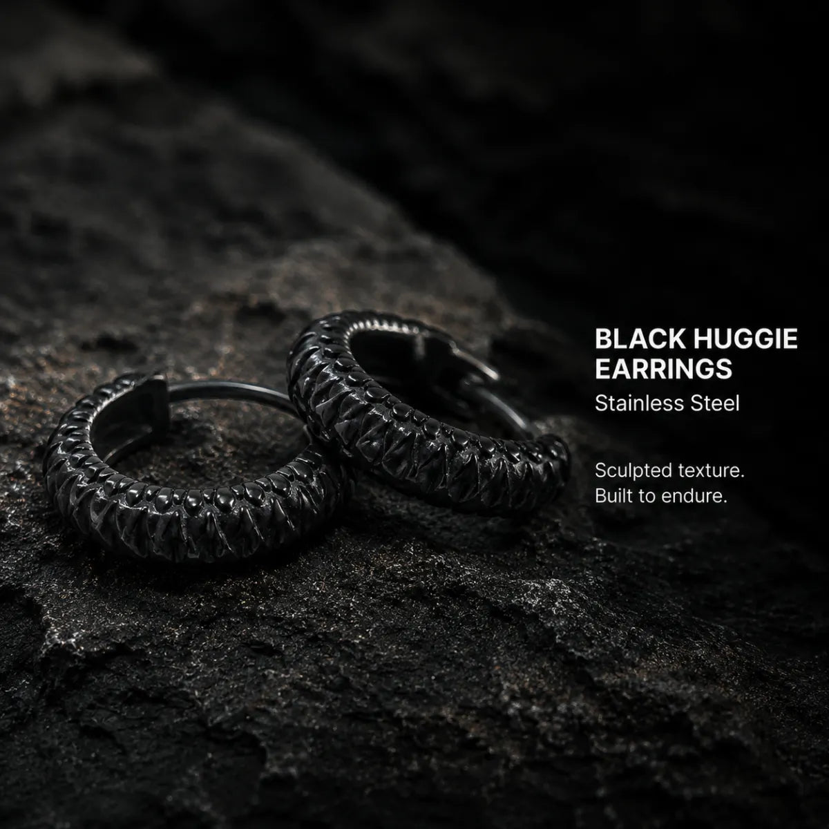 Snake Skin Hoop Earrings Black Pair Displayed on Stone Surface