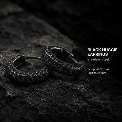 Snake Skin Hoop Earrings Black Pair Displayed on Stone Surface