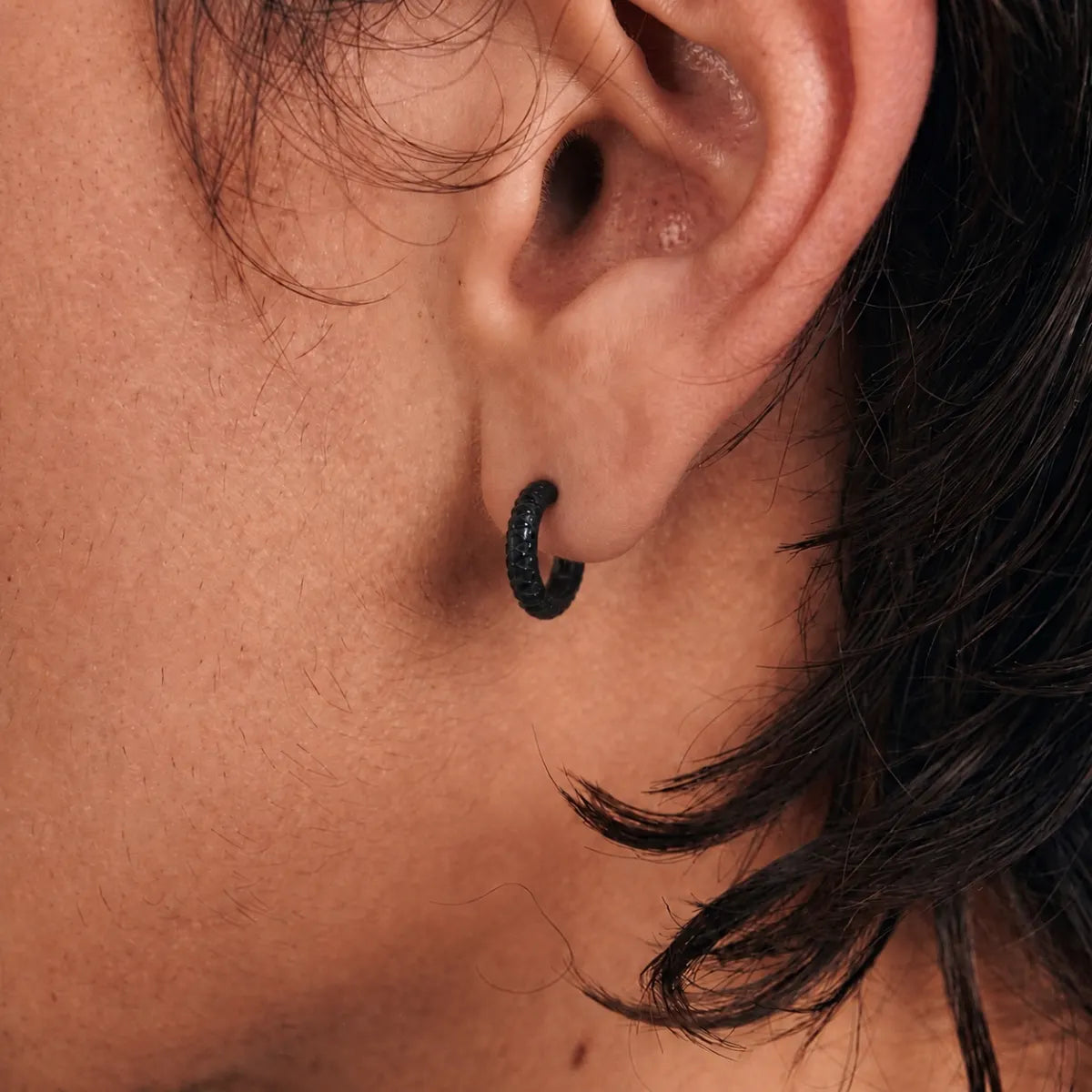 Snake Skin Hoop Earrings Black Worn by Male Model Close Up