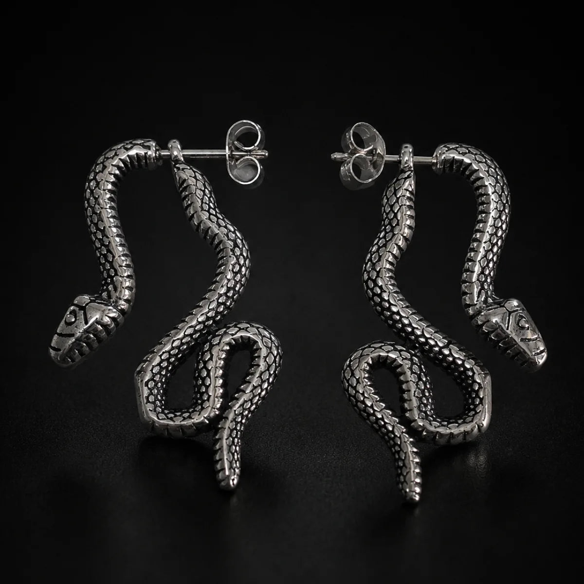 Snake Stud Earrings Silver Pair Displayed Black Background