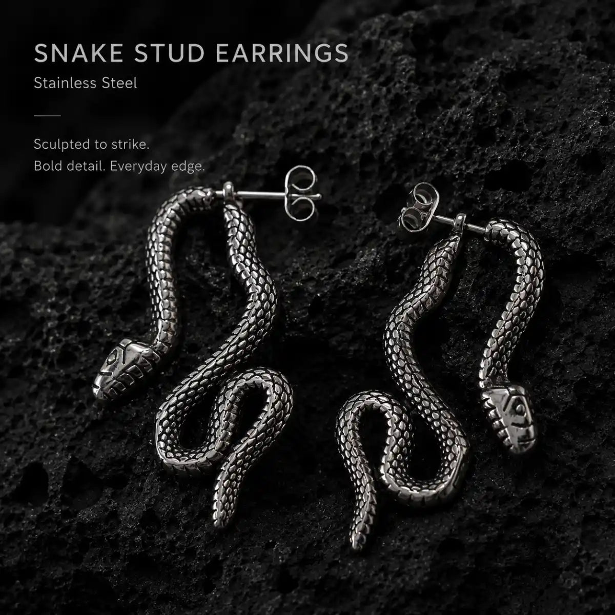 Snake Stud Earrings Silver Pair Displayed on Stone Surface