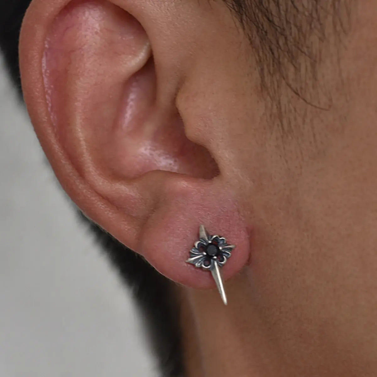 Spike Cross Stud Earrings Worn by Male Model Close Up