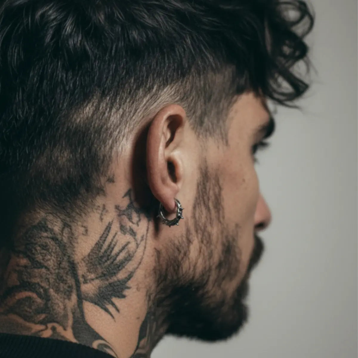 Spiked Thorn Huggie Hoop Earrings Worn by Male Model Back Close Up