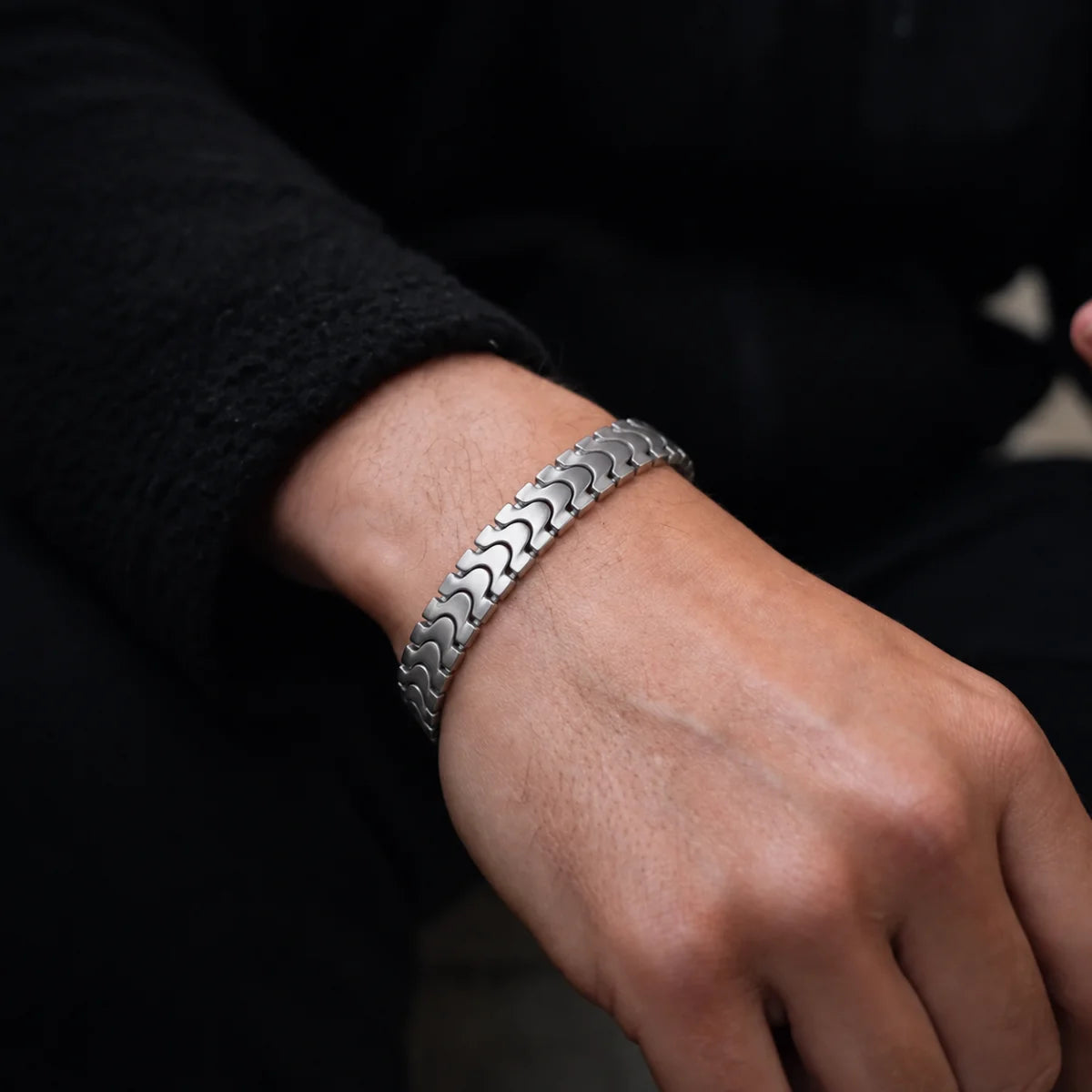 Spine Link Bracelet Silver 12mm Worn on Model Hand Close Up