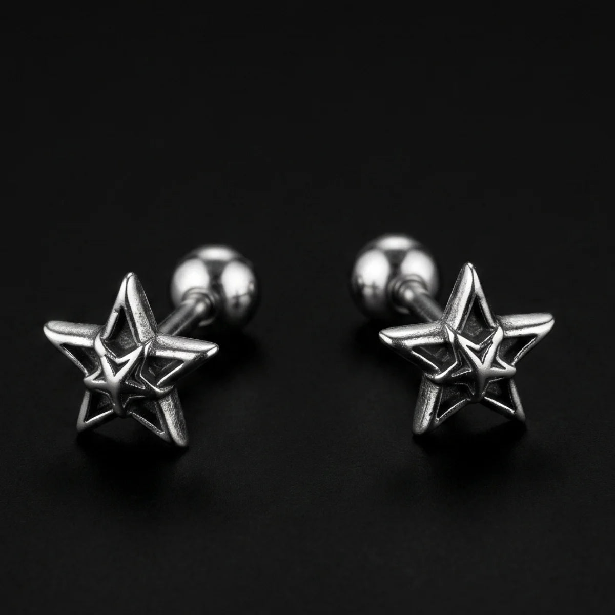 Star Cartilage Stud Earrings Silver Close Up Black Background