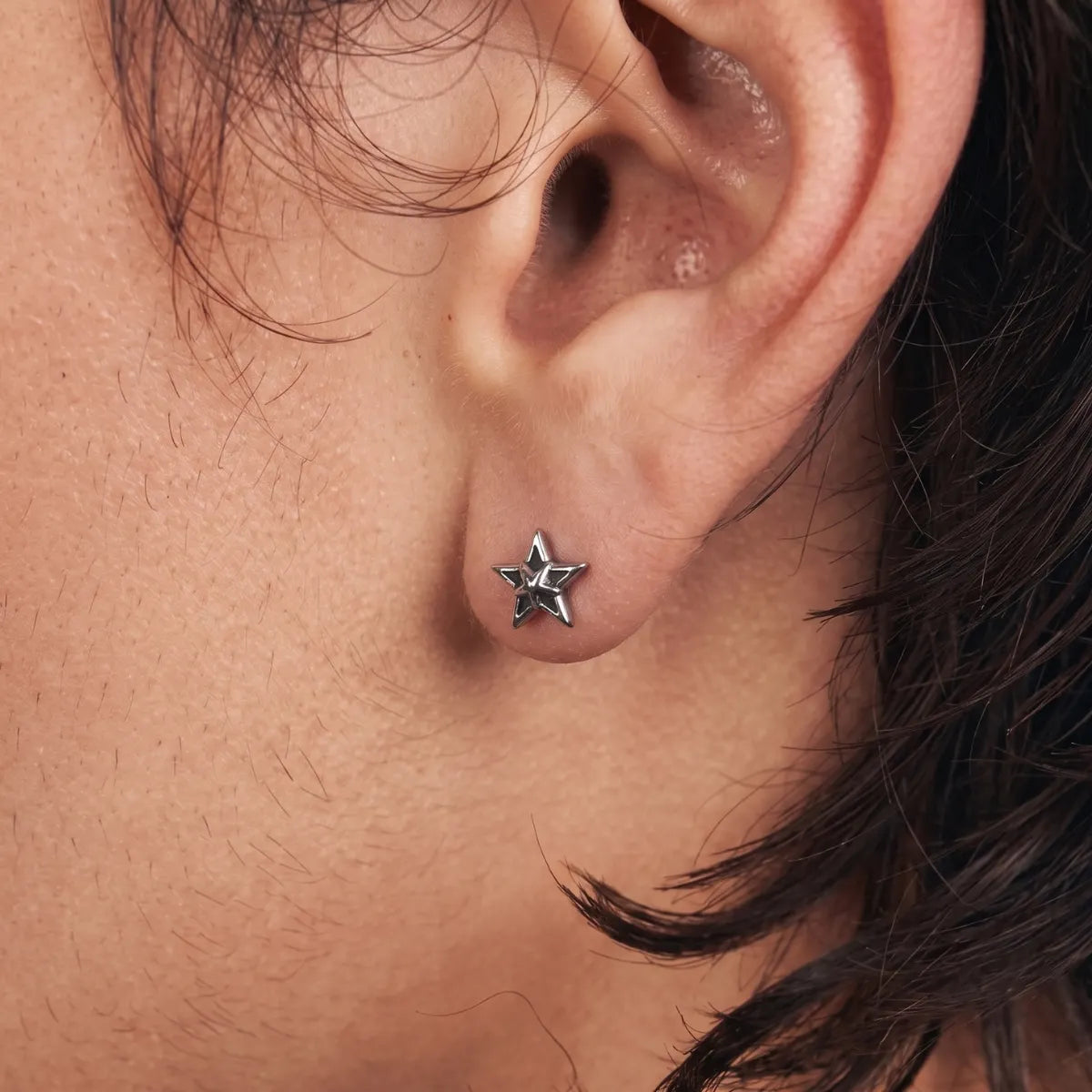 Star Cartilage Stud Earrings Silver Worn by Male Model Side View