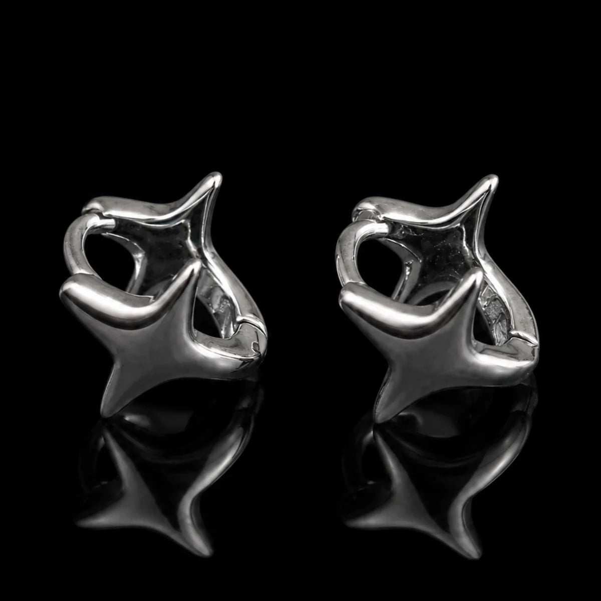 Star Huggie Earrings Silver Close Up Black Background