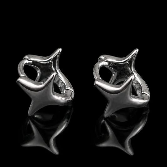 Star Huggie Earrings Silver Close Up Black Background