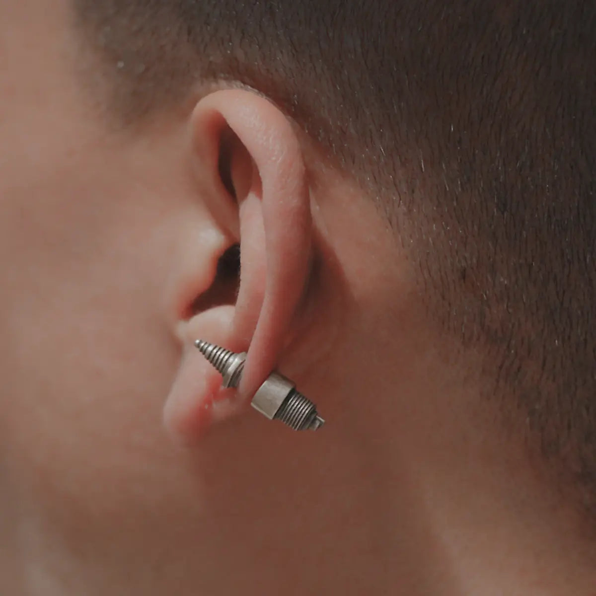 Steampunk Spark Plug Stud Earrings Worn by Male Model