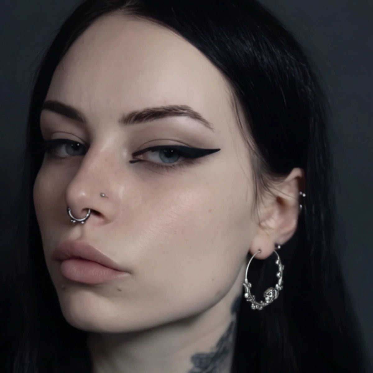 Steel Skulls on Branch Hoop Earrings Worn by Female Model Front
