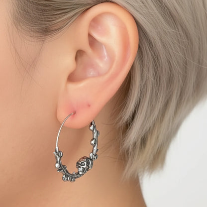 Steel Skulls on Branch Hoop Earrings Worn by Female Model Side Close Up