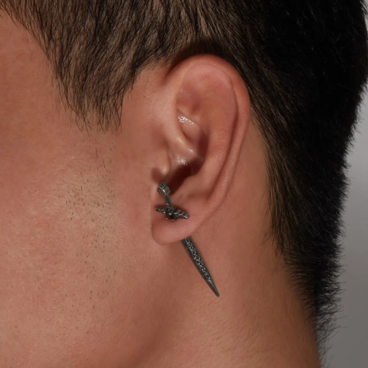 Sword Earrings Through Ear Worn by Male Model Close Up