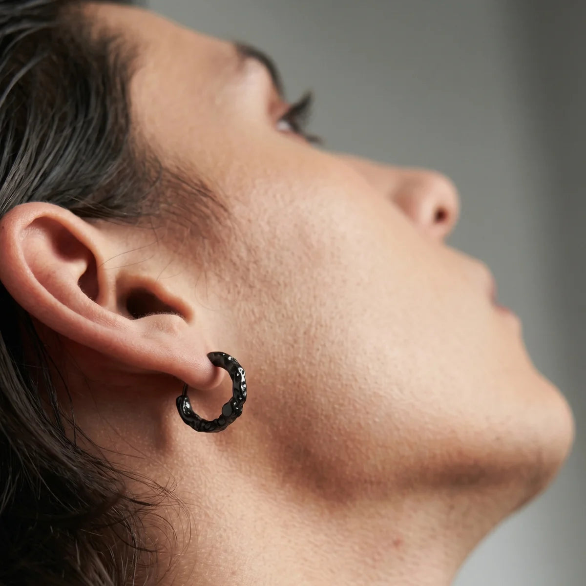 Textured Huggie Hoop Earrings Black Worn by Male Model