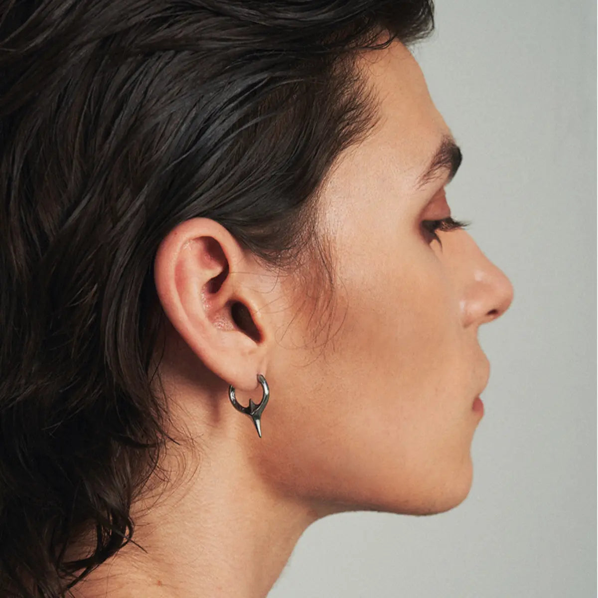 Textured Spike Huggie Hoop Earrings Worn by Male Model Close up