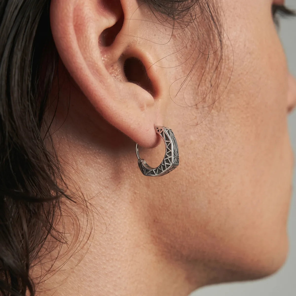 Textured Triangle Hoop Earrings Worn by Male Model Side View