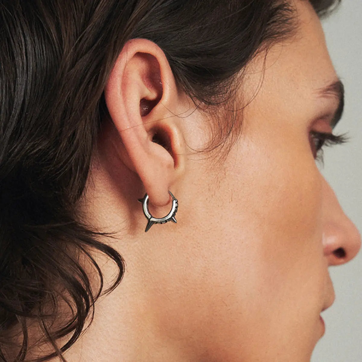 Triple Spike Huggie Hoop Earrings Worn by Male Model Front View