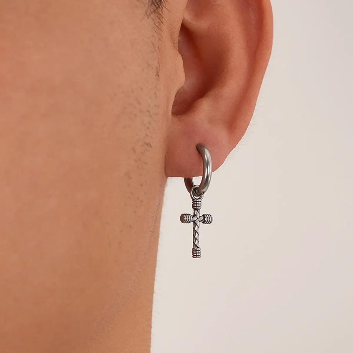Twisted Cross Dangle Hoop Earrings Worn by Male Model Close Up
