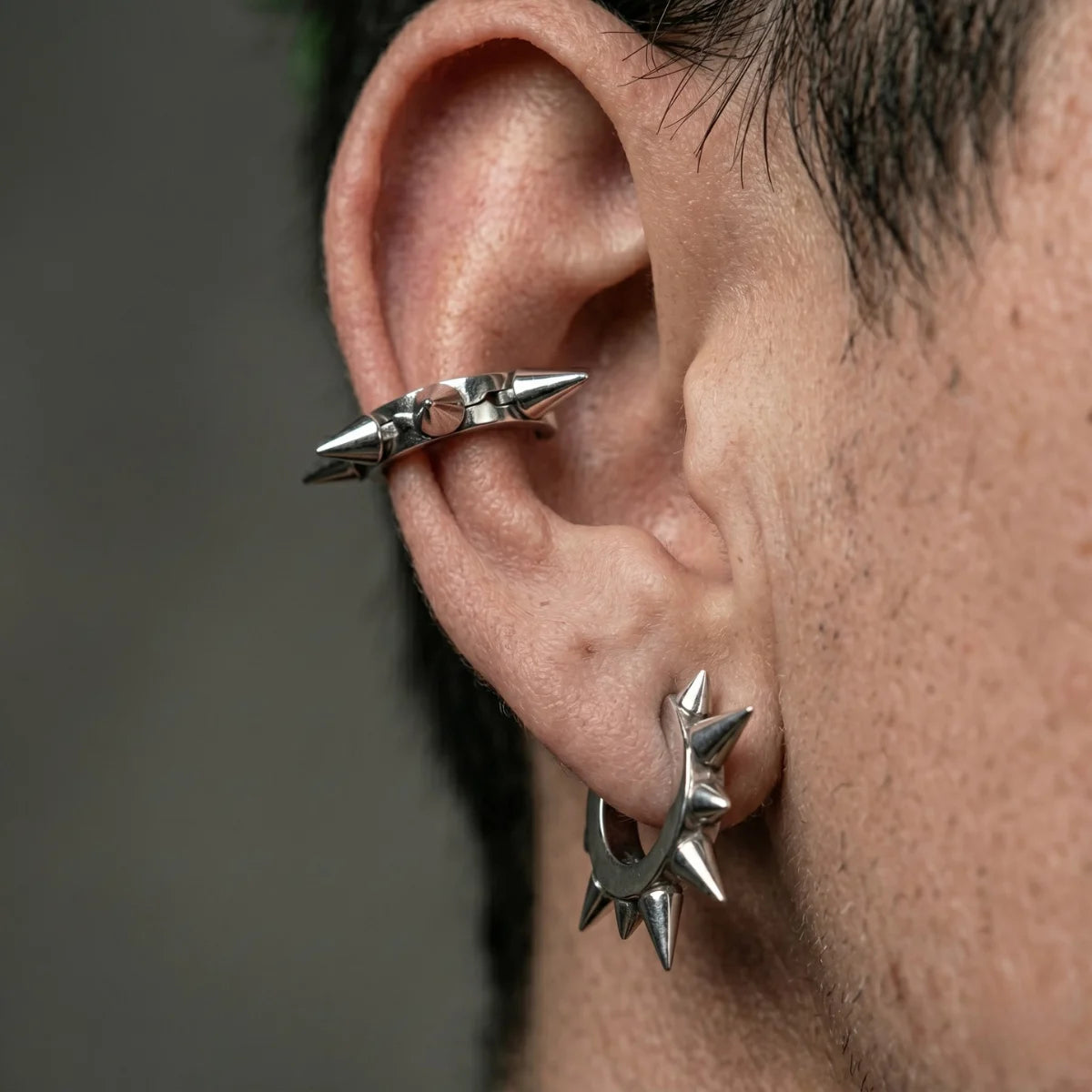 Two Large Spike Hoop Earrings Silver Worn by Male Model Close Up