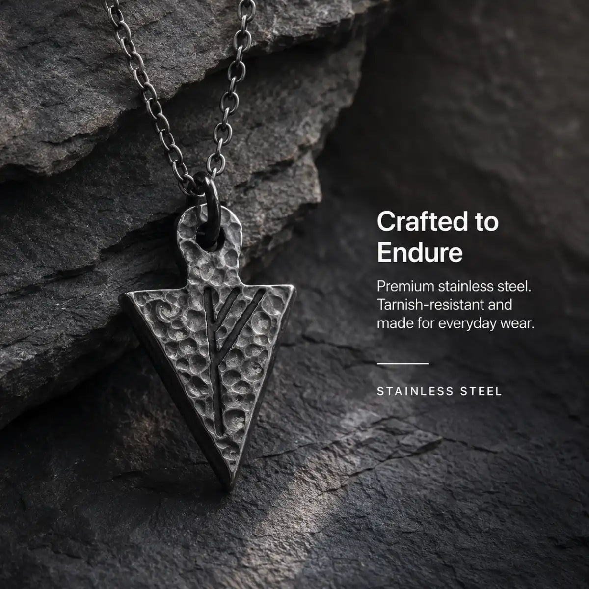 Viking Rune Arrowhead Necklace Silver Displayed on Stone Surface