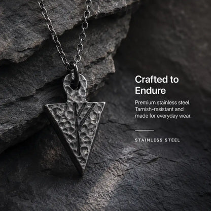 Viking Rune Arrowhead Necklace Silver Displayed on Stone Surface